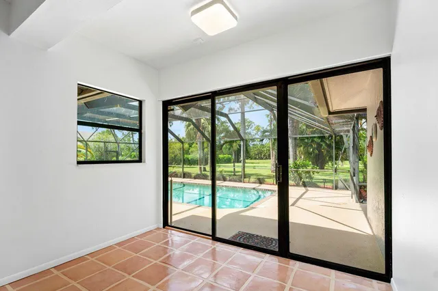 a view of an empty room with a chandelier fan