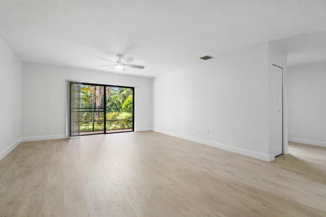 a bathroom with a granite countertop bathtub sink vanity and mirror