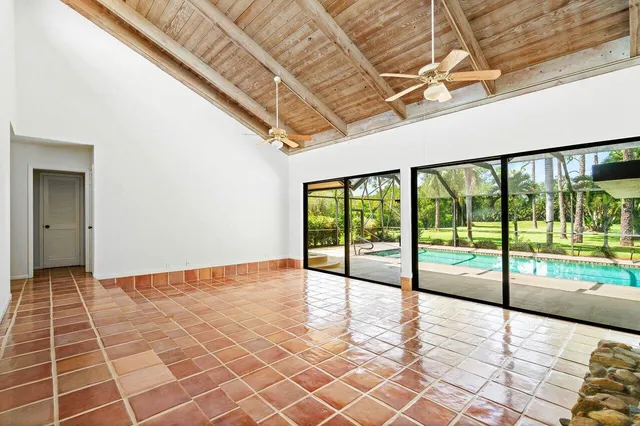 a living room with fireplace furniture and a floor to ceiling window