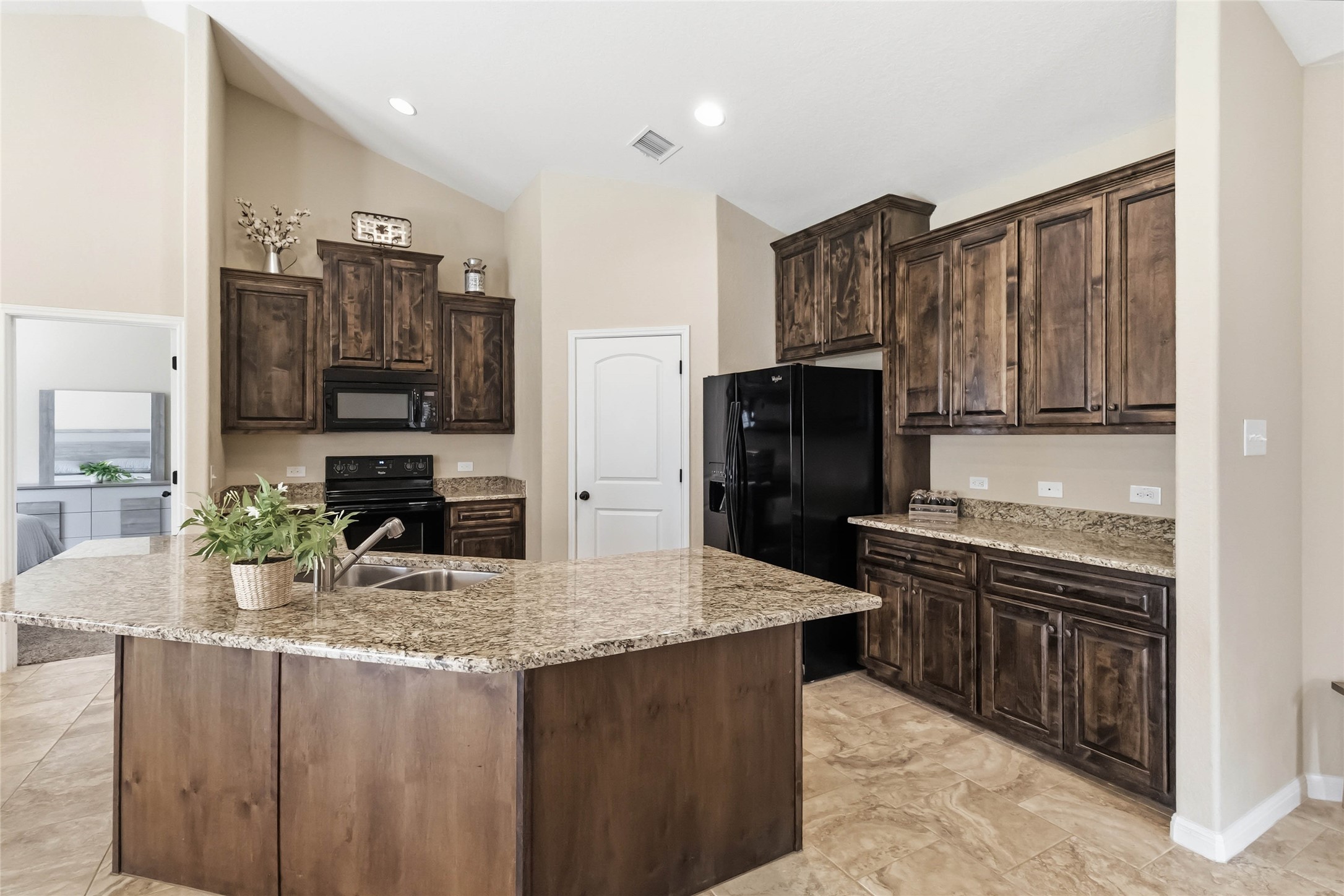 285 Hummingbird Way Martindale, TX 78655 - Photo 7 of 40 a kitchen with stainless steel appliances granite countertop a sink stove and refrigerator