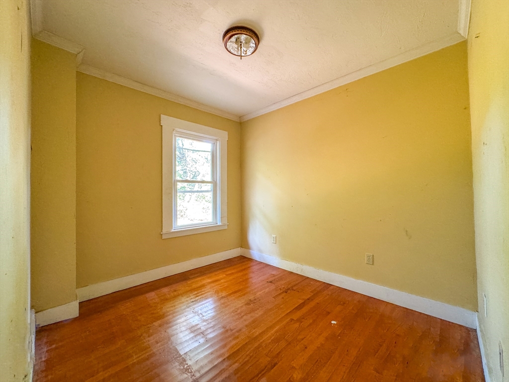 14 Brook Street Ayer, MA 01432 - Photo 18 of 26 a view of an empty room with wooden floor and a window
