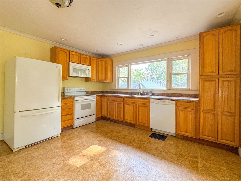 14 Brook Street Ayer, MA 01432 - Photo 21 of 26 a kitchen with white cabinets and white appliances