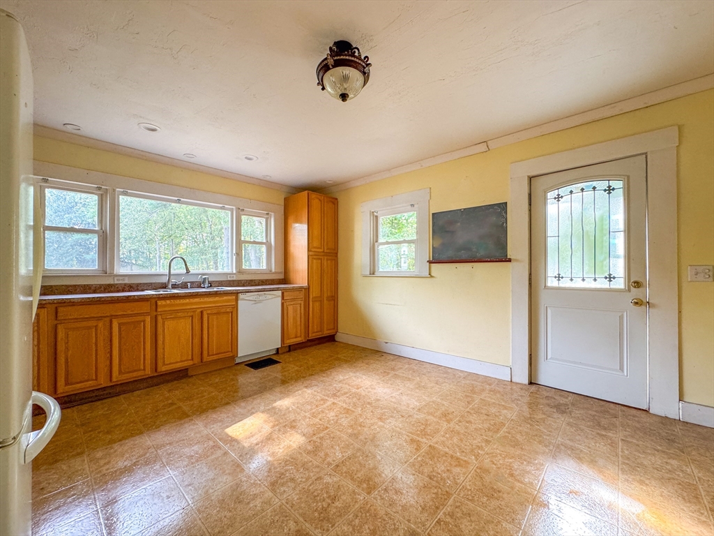 14 Brook Street Ayer, MA 01432 - Photo 22 of 26 a view of an empty room with a window and a kitchen