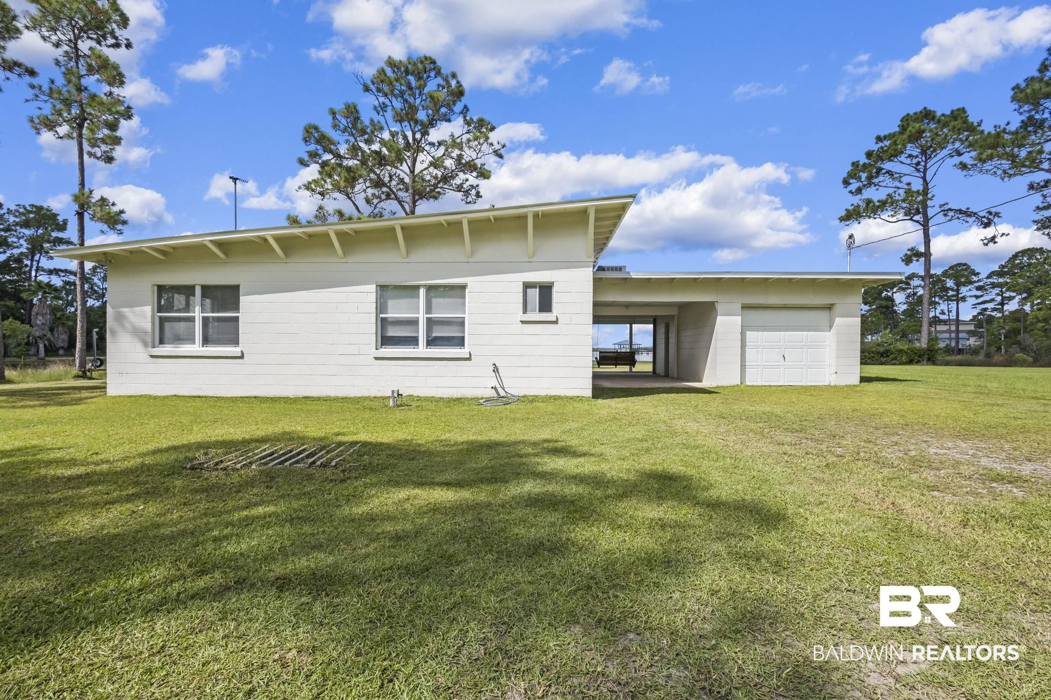 7849 Bayshore Drive Elberta, AL 36530 - Photo 3 of 47 Back of property featuring a carport and a lawn