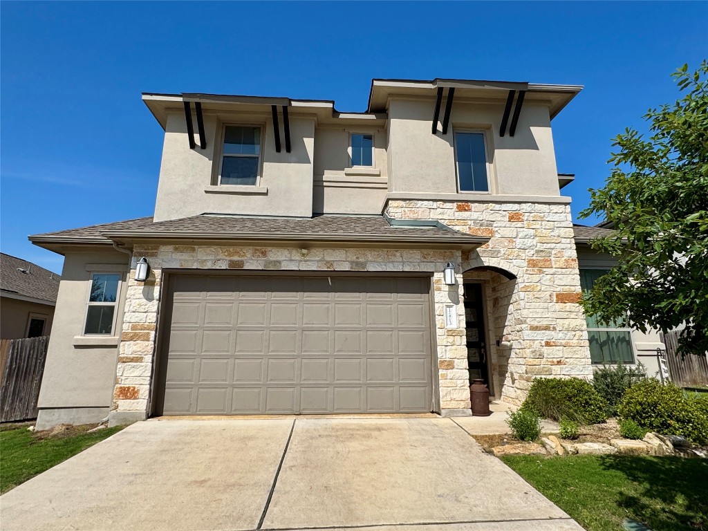 a front view of a house with a garage