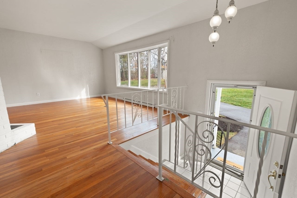 8 Spring Lane Sharon, MA 02067 - Photo 5 of 39 a view of an empty room with wooden floor and a window