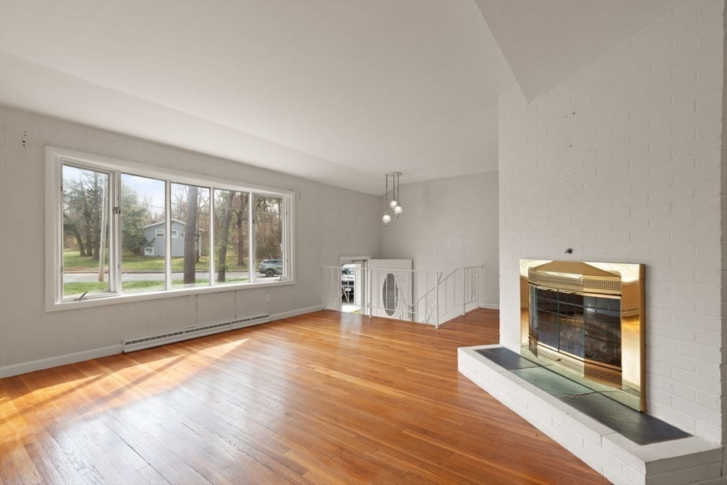 8 Spring Lane Sharon, MA 02067 - Photo 8 of 39 a view of empty room with wooden floor and fan