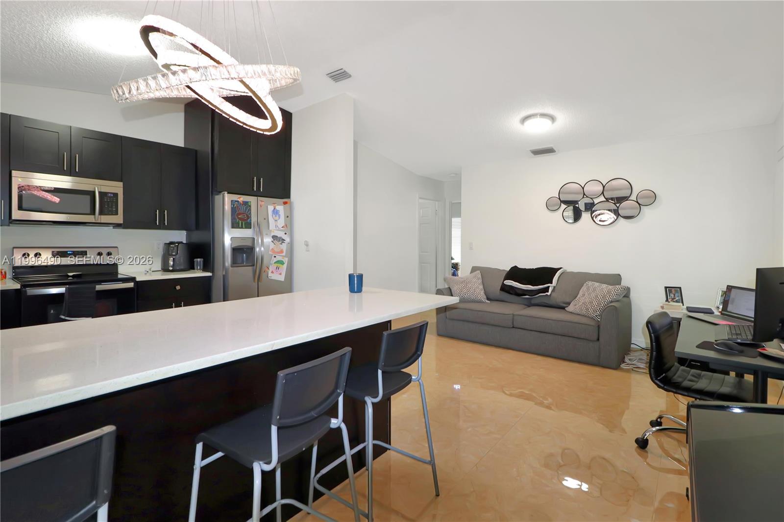 10940 Southwest 143rd Court Miami, FL 33186 - Photo 13 of 31 a living room with stainless steel appliances furniture a dining table and chairs