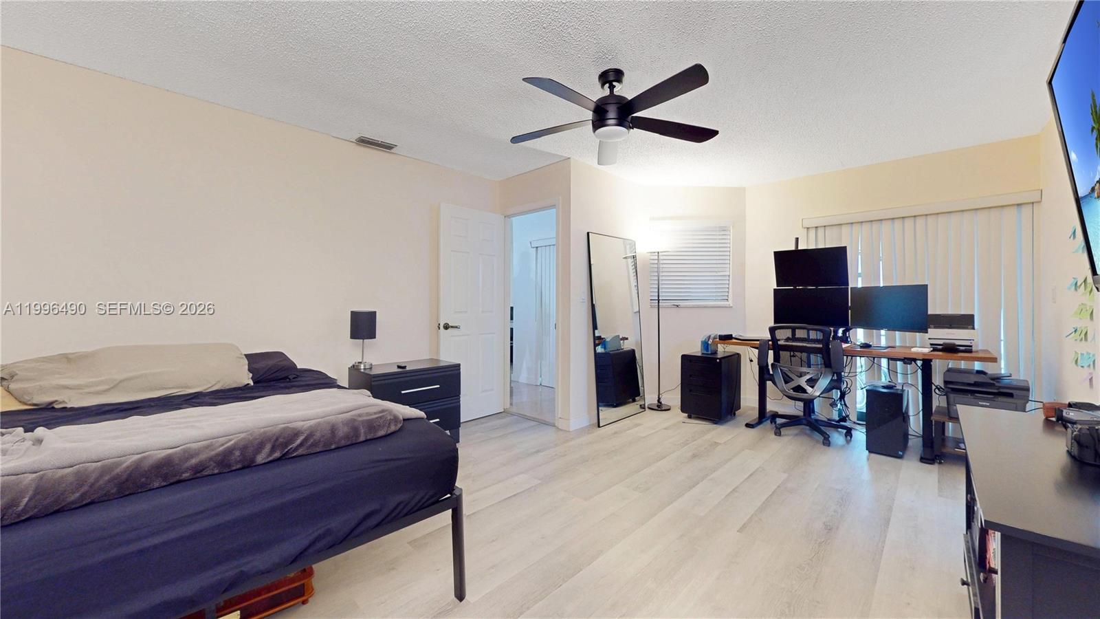 10940 Southwest 143rd Court Miami, FL 33186 - Photo 15 of 31 a bedroom with a bed and a flat screen tv