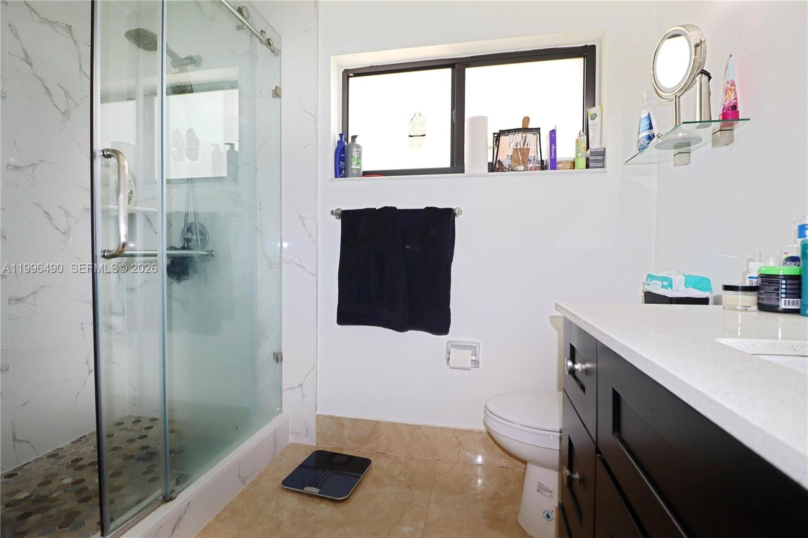 10940 Southwest 143rd Court Miami, FL 33186 - Photo 17 of 31 a bathroom with a sink a toilet and shower