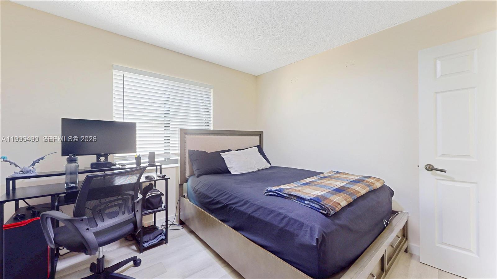 10940 Southwest 143rd Court Miami, FL 33186 - Photo 20 of 31 a bedroom with a bed and a flat screen tv