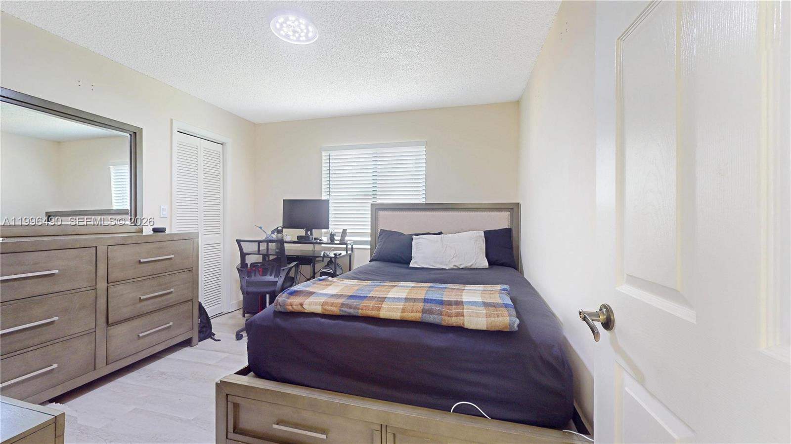 10940 Southwest 143rd Court Miami, FL 33186 - Photo 21 of 31 a bedroom with a bed and furniture