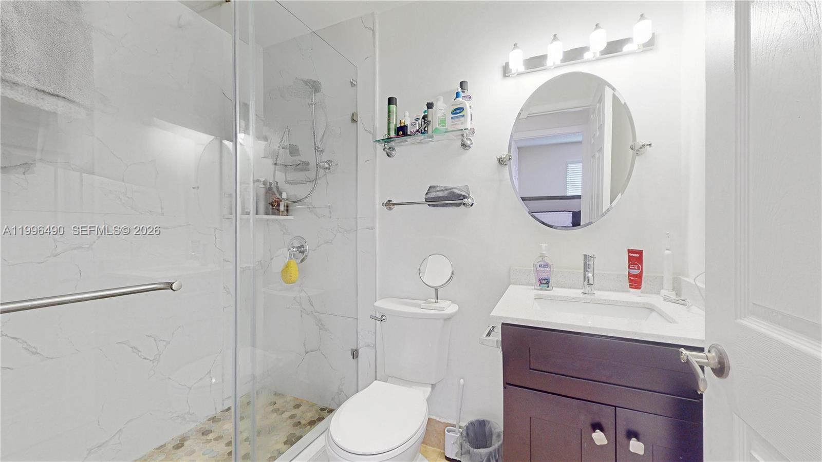 10940 Southwest 143rd Court Miami, FL 33186 - Photo 22 of 31 a bathroom with a sink a toilet and shower