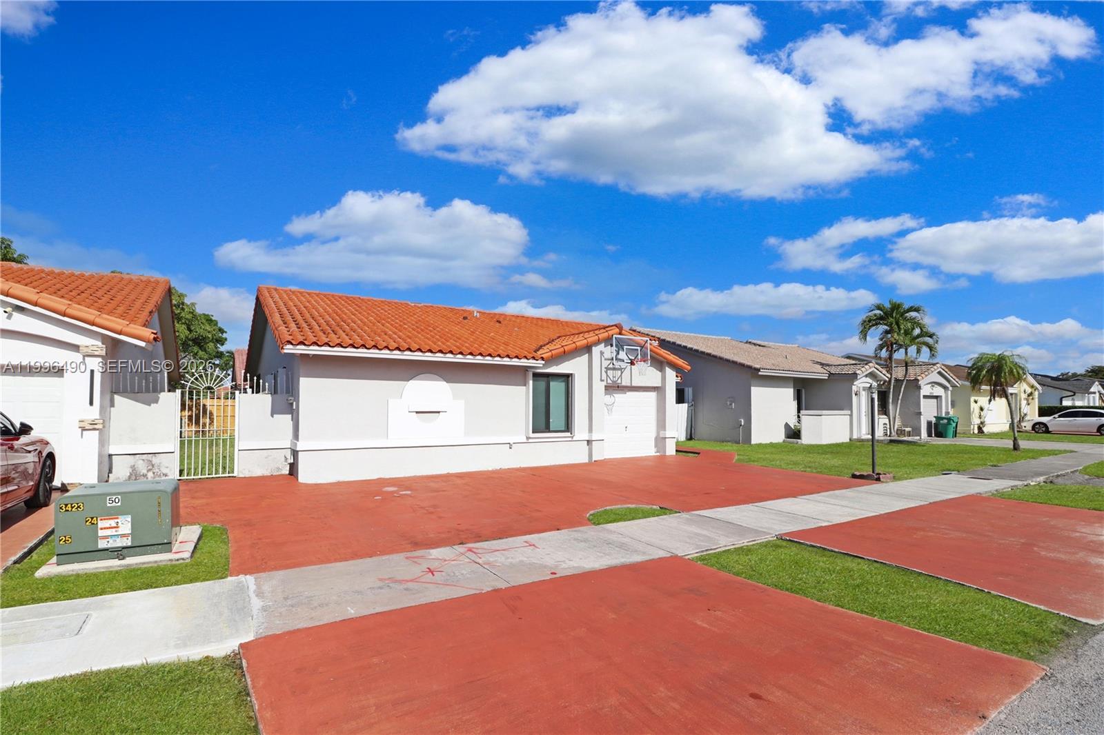 10940 Southwest 143rd Court Miami, FL 33186 - Photo 30 of 31 a front view of a house with a yard and garage