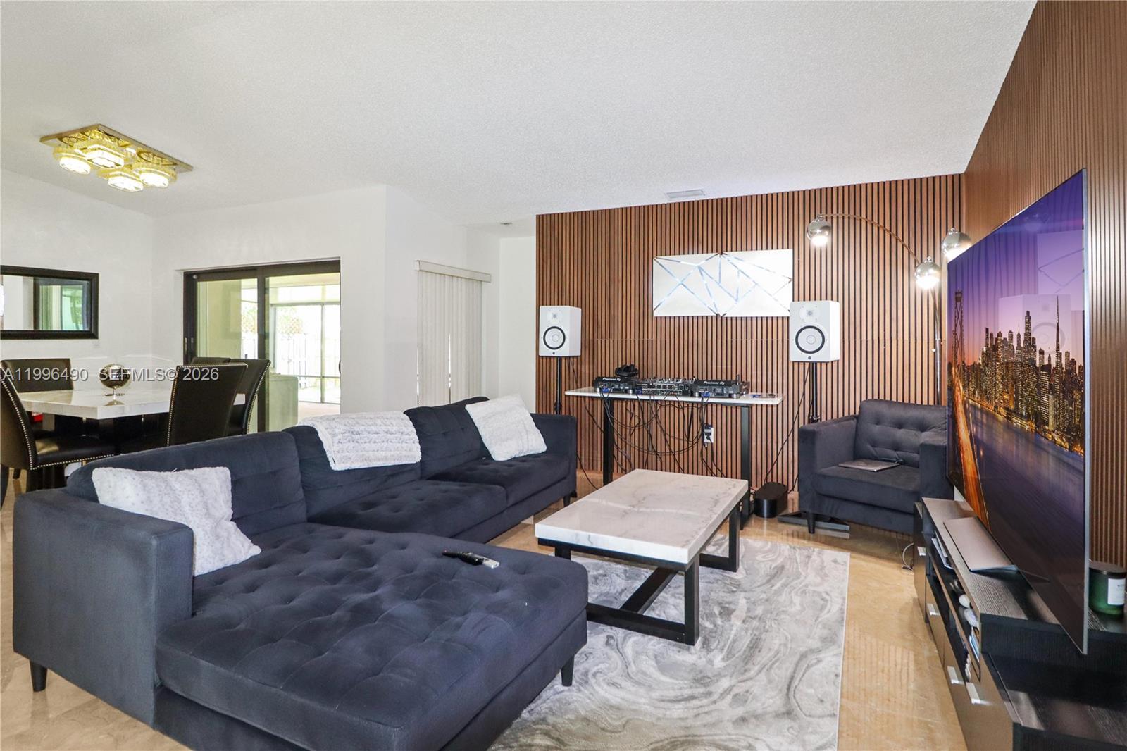 10940 Southwest 143rd Court Miami, FL 33186 - Photo 4 of 31 a living room with furniture and a flat screen tv