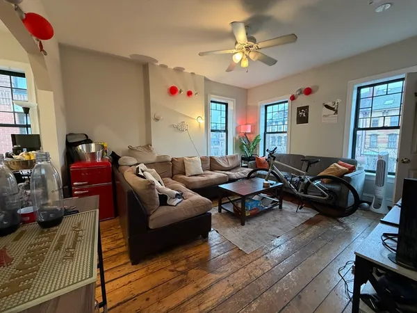 a living room with furniture or couch and a ceiling fan