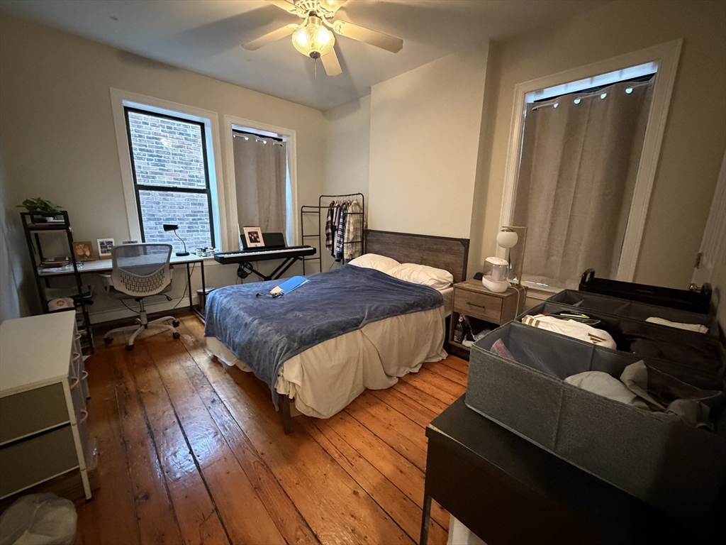 1675 Washington Street, Unit 3 Boston, MA 02118 - Photo 4 of 6 a bedroom with a bed and wooden floor