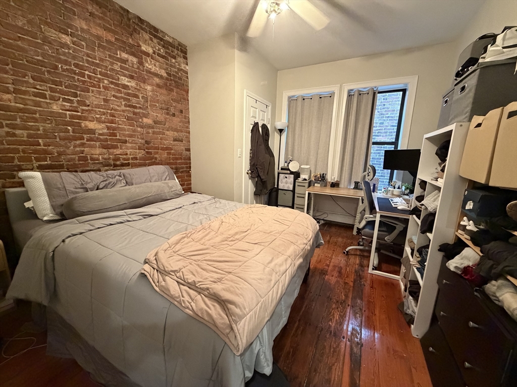 1675 Washington Street, Unit 3 Boston, MA 02118 - Photo 5 of 6 a bed room with a bed and a flat tv screen