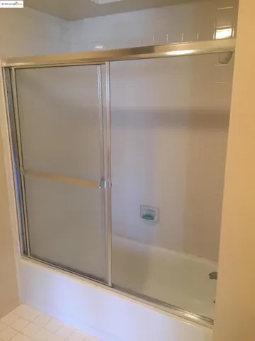 a bathroom with a glass shower door