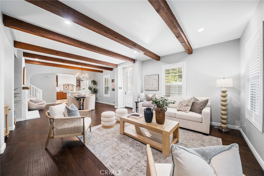 Spacious living room with exposed beams, double pane windows with plantation shutters and upgraded lighting!