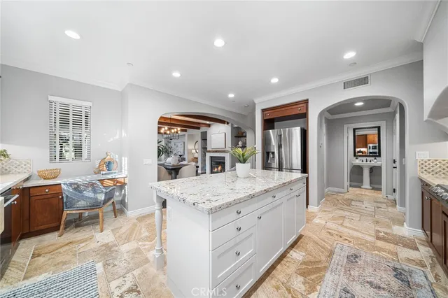 a view of a kitchen counter space with wooden floor and staircase