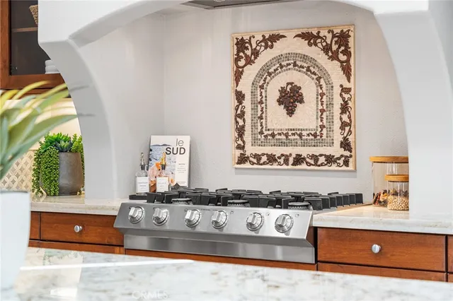 a kitchen with stainless steel appliances kitchen island granite countertop a sink and cabinets