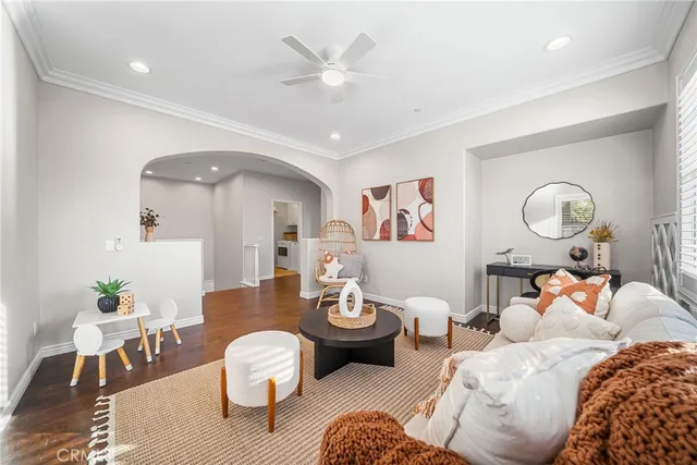 a living room with furniture and wooden floor