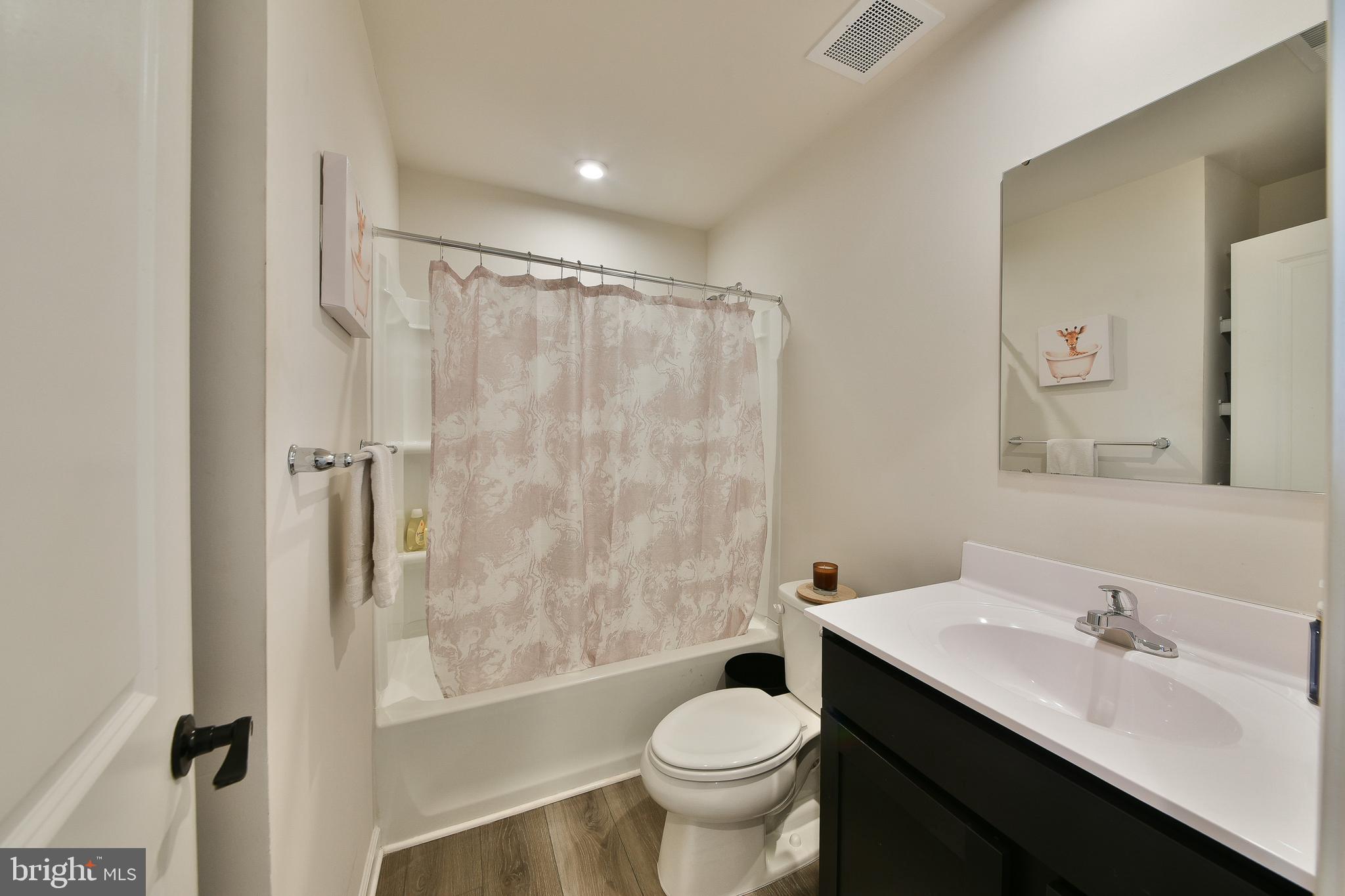 24 Wendowski Street Beverly, NJ 08010 - Photo 12 of 19 a bathroom with a sink toilet a mirror and shower