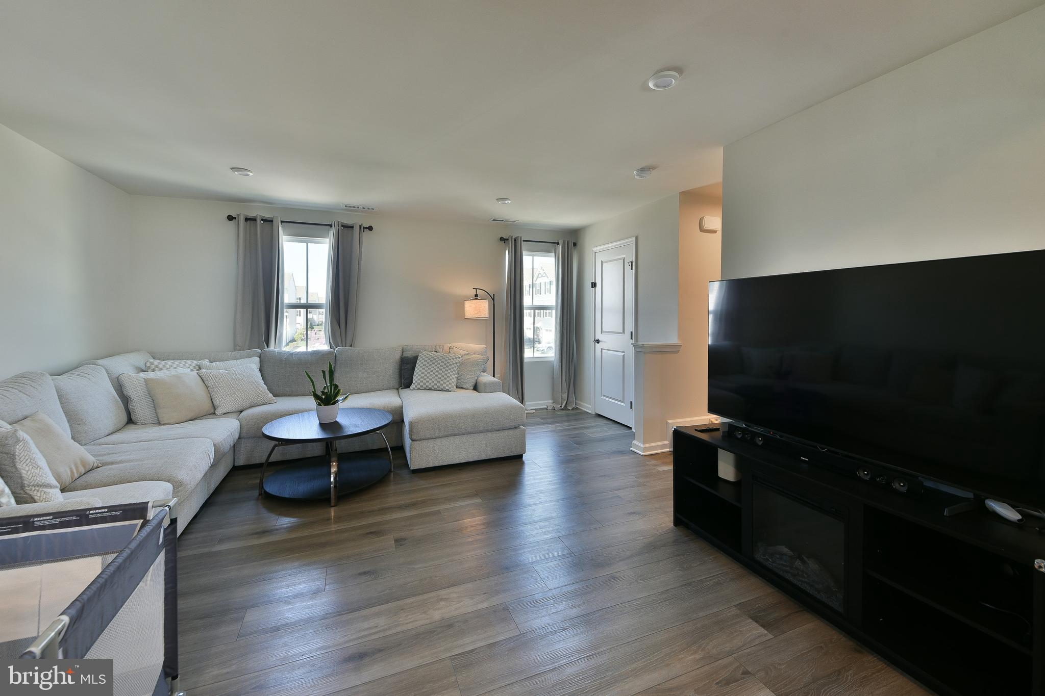 24 Wendowski Street Beverly, NJ 08010 - Photo 4 of 19 a living room with furniture flat screen tv and wooden floor