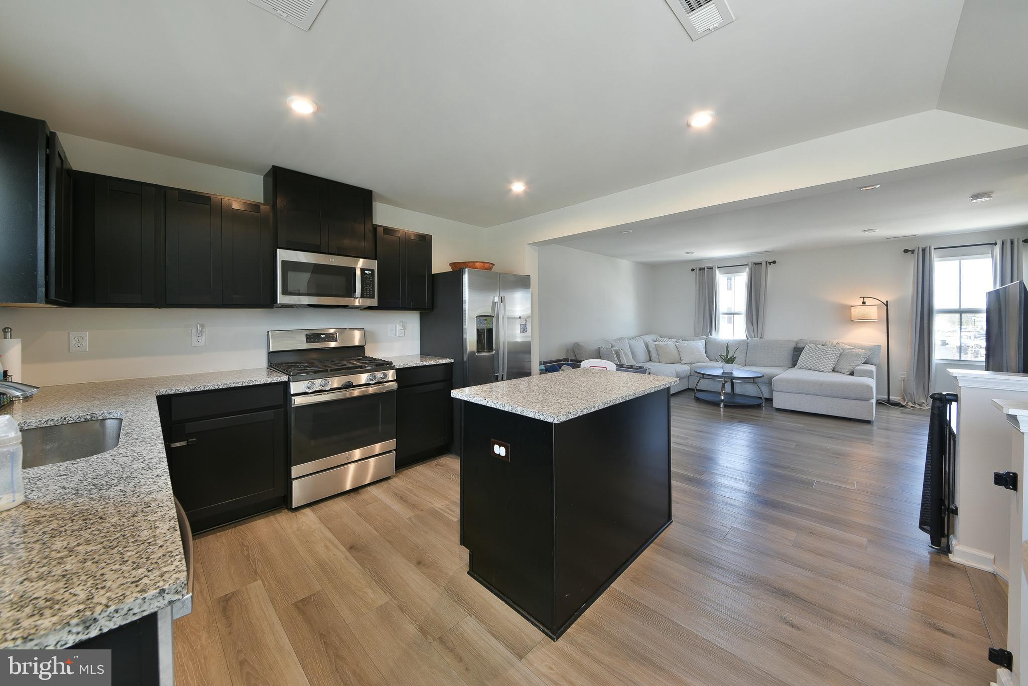 24 Wendowski Street Beverly, NJ 08010 - Photo 5 of 19 a kitchen with kitchen island granite countertop stainless steel appliances stove sink and cabinets