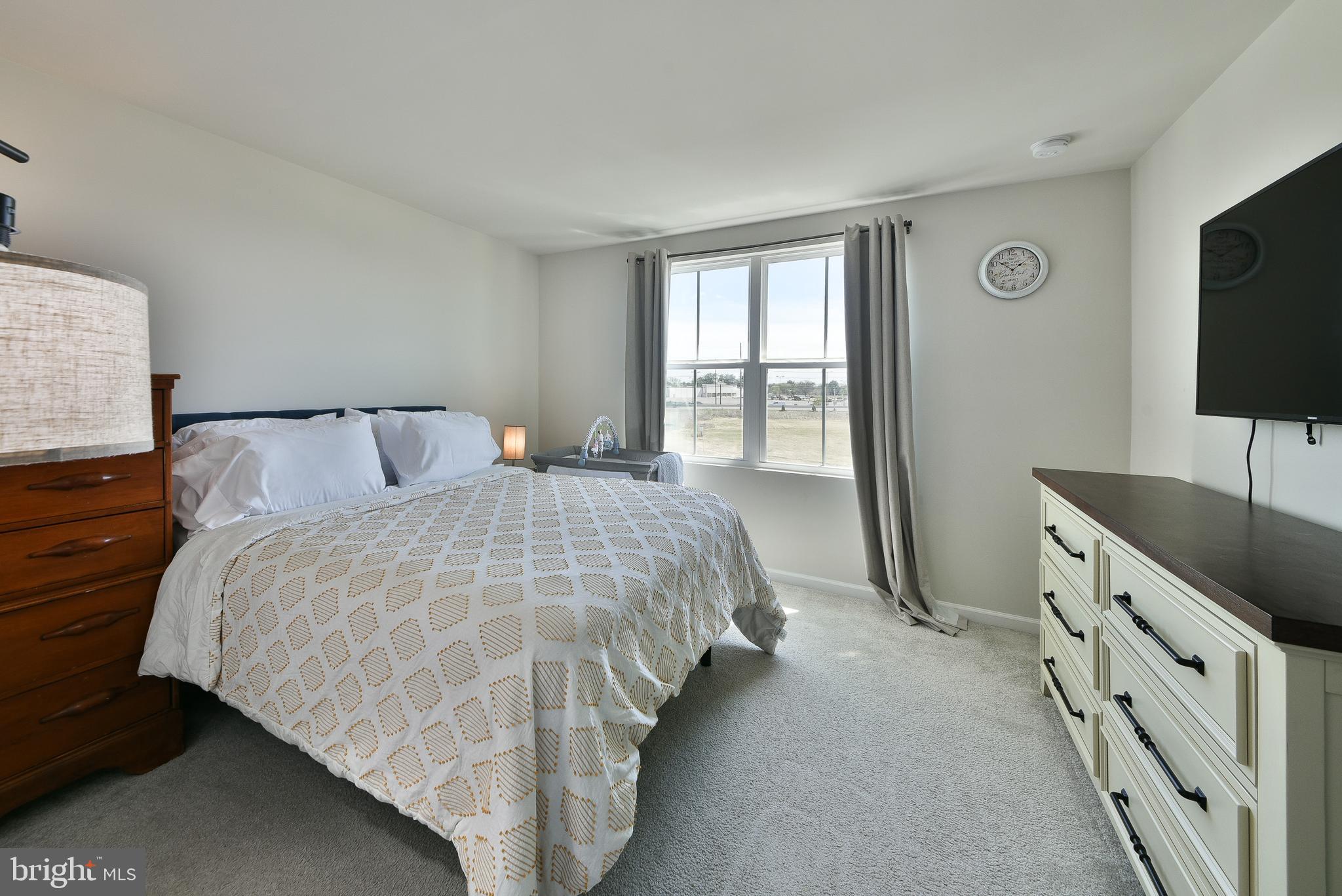 24 Wendowski Street Beverly, NJ 08010 - Photo 10 of 19 a bedroom with a bed and a flat tv screen on dresser
