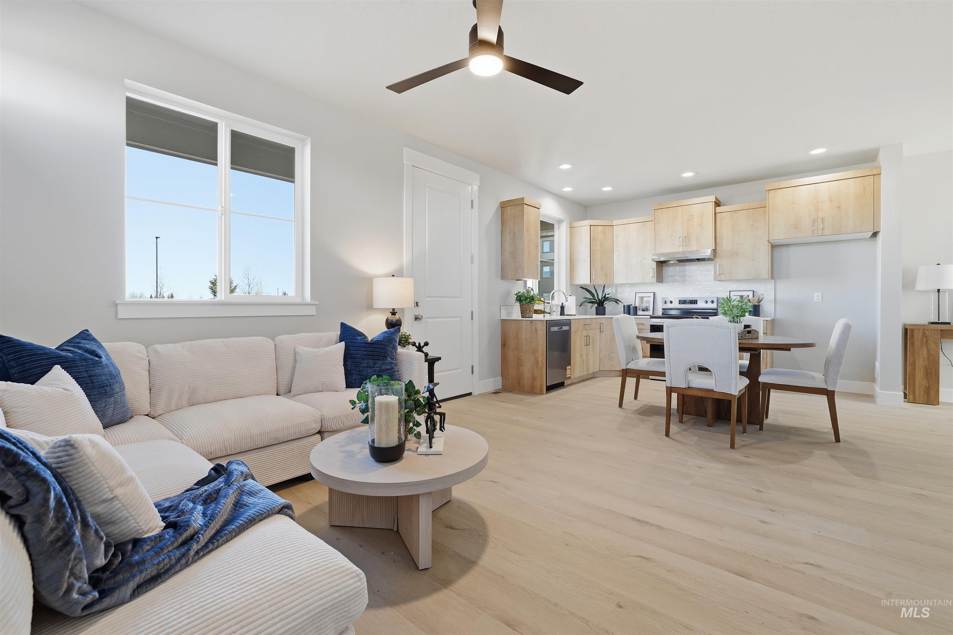 Living room featuring plenty of natural light, light wood finished floors, recessed lighting, and ceiling fan