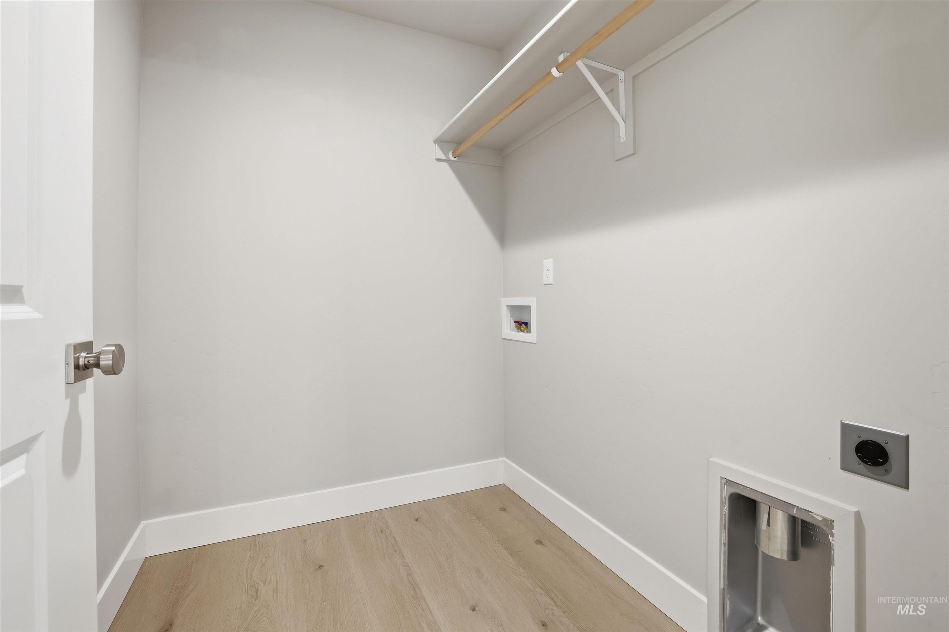 1172 East Cottage Street Kuna, ID 83634 - Photo 14 of 22 Washroom with hookup for a washing machine, light wood-style floors, and electric dryer hookup