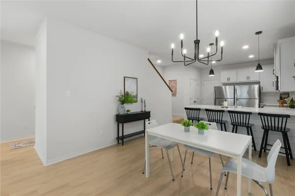 a view of a dining room with furniture and a chandelier