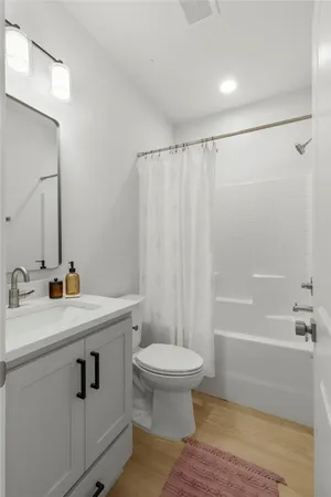 a bathroom with a sink toilet and shower