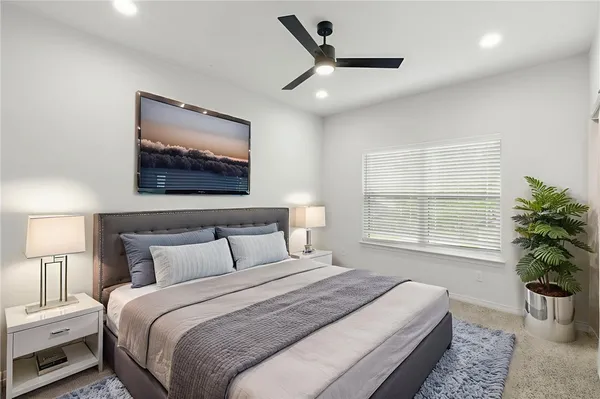 an empty room with a window and a ceiling fan