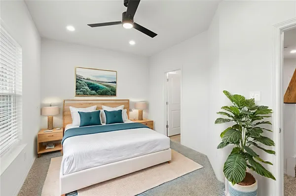 an empty room with ceiling fan and window