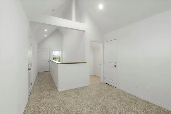 an empty room with a cabinet and mirror