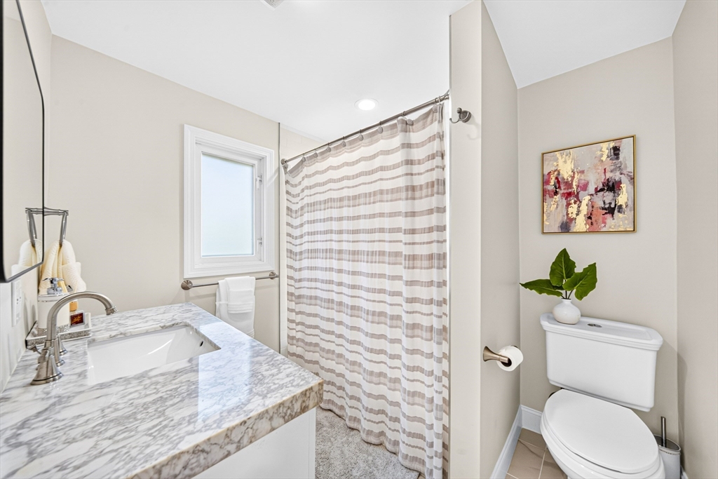 24 Miller Road Wilmington, MA 01887 - Photo 31 of 40 a bathroom with a granite countertop bathtub sink vanity mirror and toilet