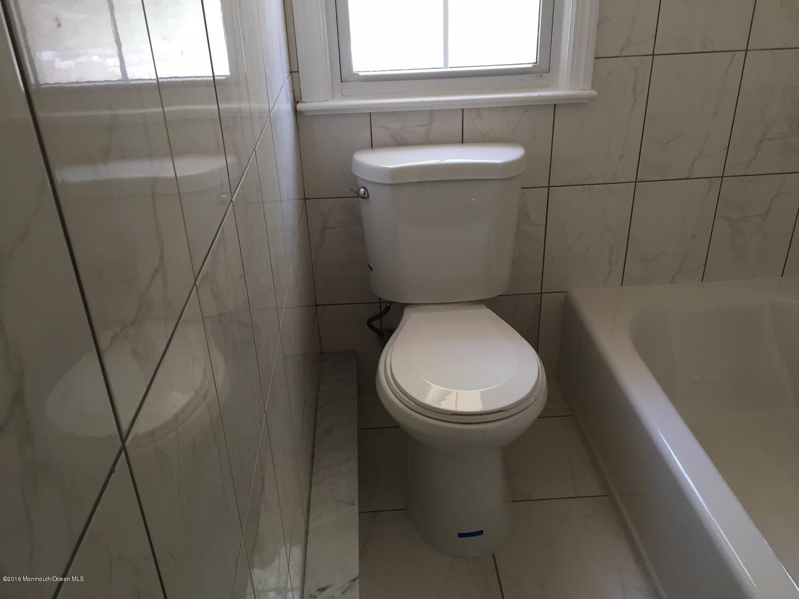 521 Burlington Road Freehold, NJ 07728 - Photo 8 of 13 a bathroom with a toilet and a shower