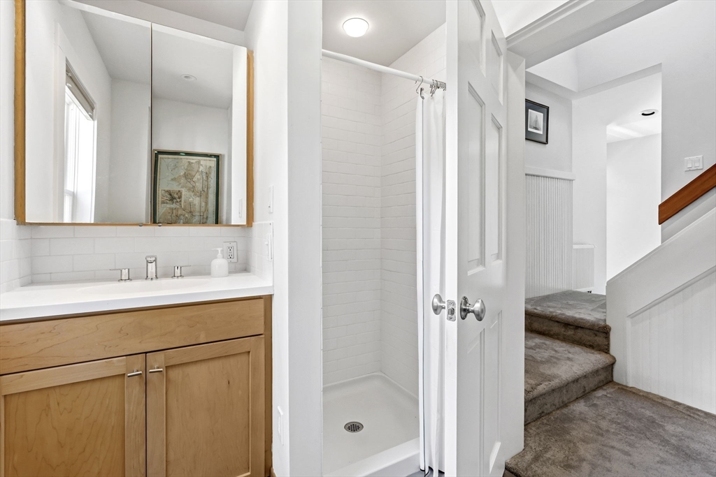58 Front Street Northampton, MA 01053 - Photo 21 of 42 a bathroom with a granite countertop sink mirror and double