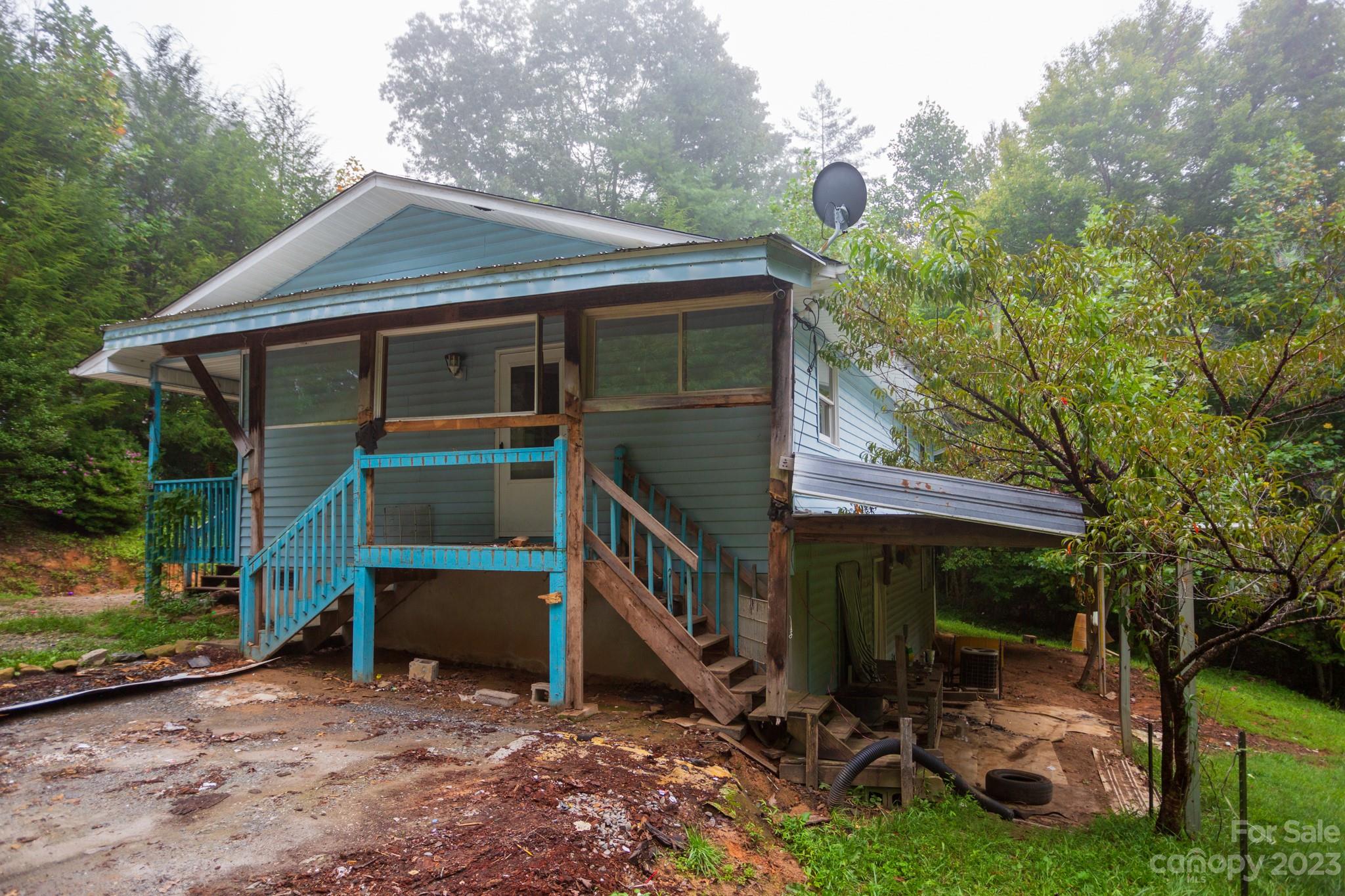 88 Adams Drive Brevard, NC 28712 - Photo 1 of 20 a backyard of a house with barbeque oven and table