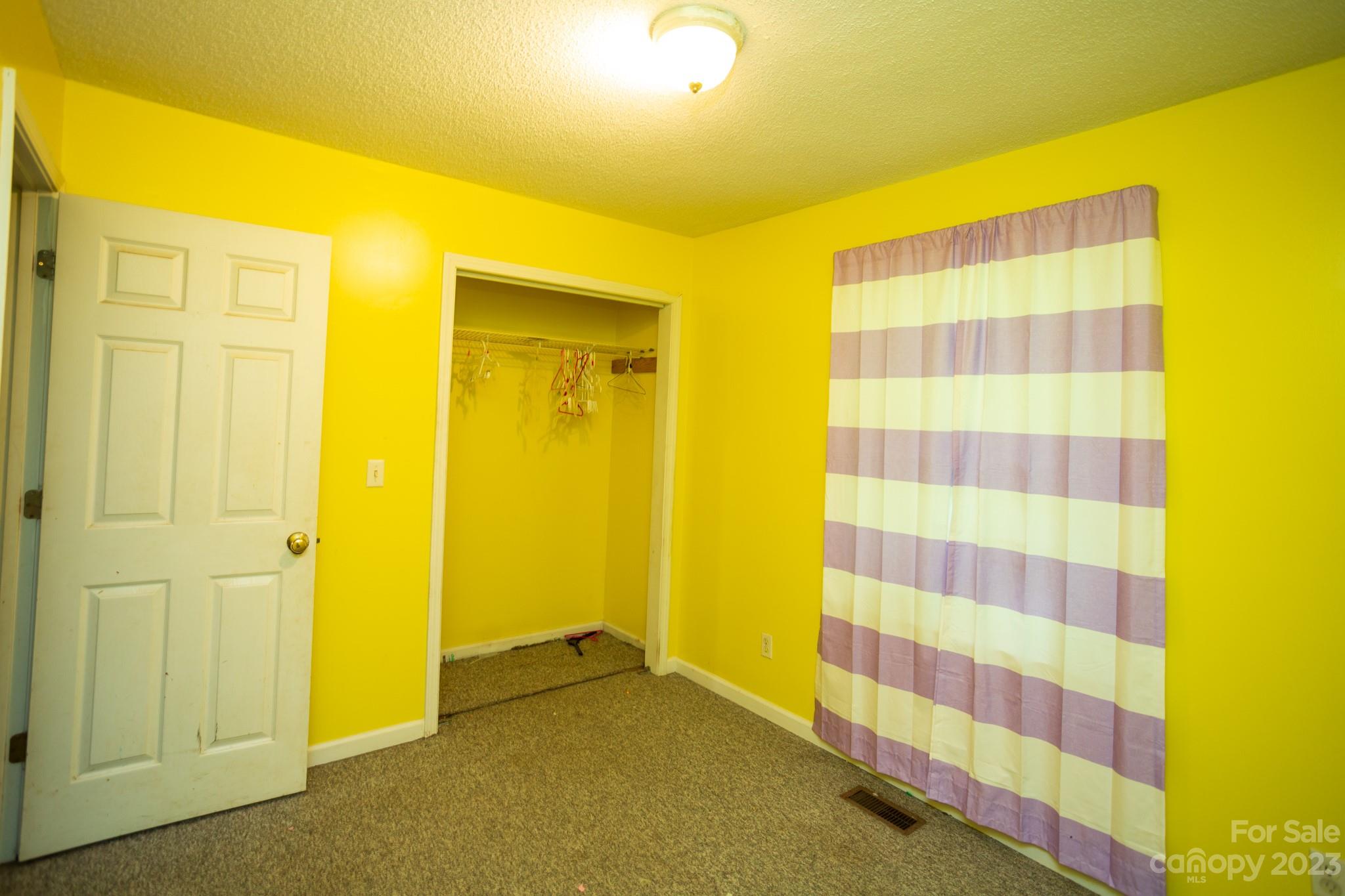88 Adams Drive Brevard, NC 28712 - Photo 13 of 20 a view of bathroom with a shower curtain and a curtain