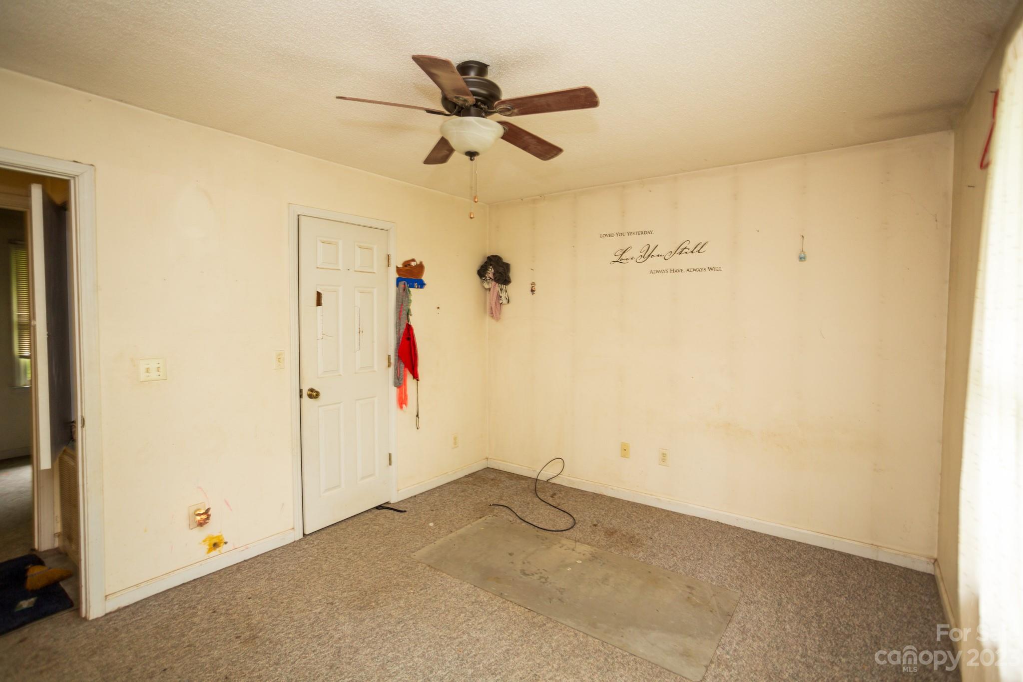 88 Adams Drive Brevard, NC 28712 - Photo 19 of 20 an empty room with a ceiling fan and a window