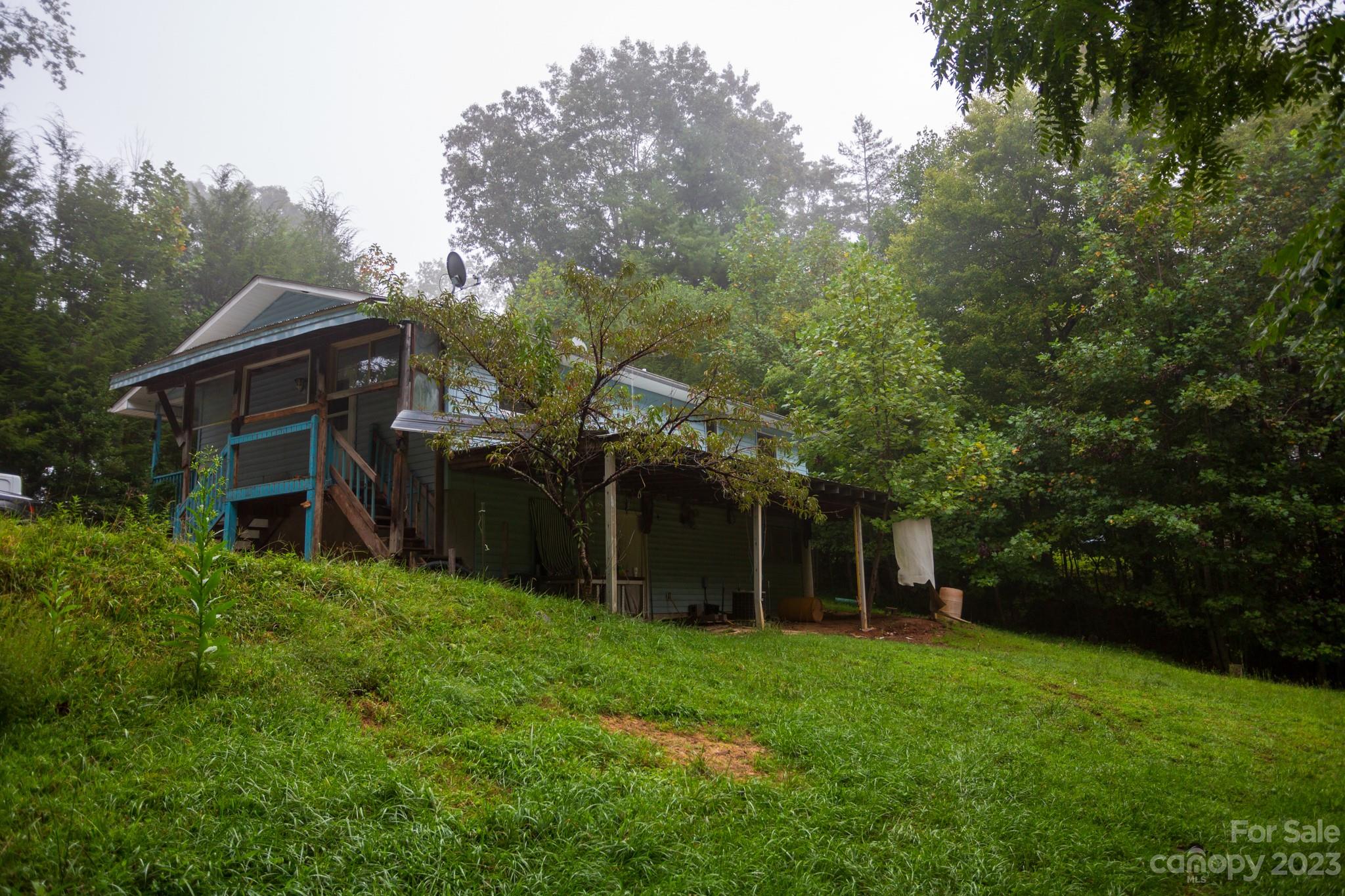 88 Adams Drive Brevard, NC 28712 - Photo 2 of 20 a view of a house with backyard and garden