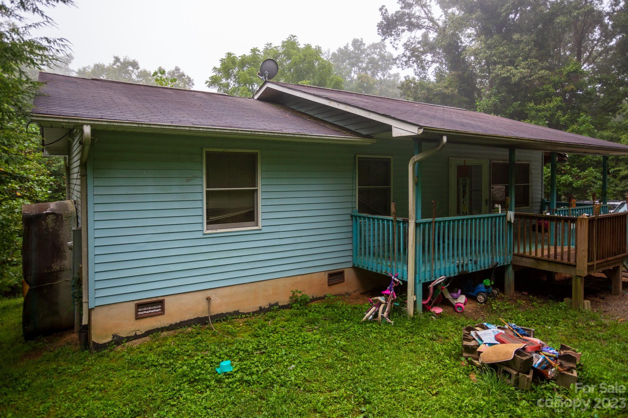 88 Adams Drive Brevard, NC 28712 - Photo 6 of 20 a view of a chair and table in backyard of the house
