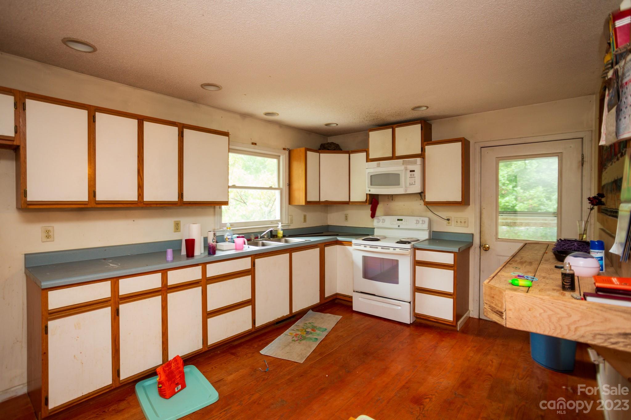 88 Adams Drive Brevard, NC 28712 - Photo 9 of 20 a kitchen with stainless steel appliances kitchen island granite countertop a sink and cabinets