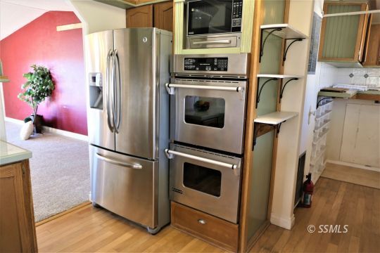 400 South Guam Street Ridgecrest, CA 93555 - Photo 12 of 39 a kitchen with stainless steel appliances a refrigerator sink and microwave