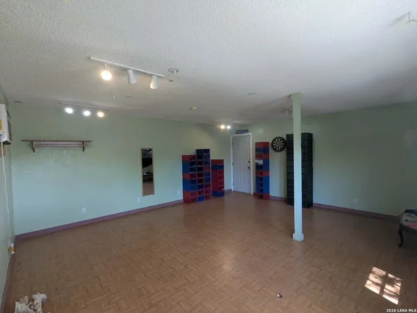 an empty room with a projector and closet