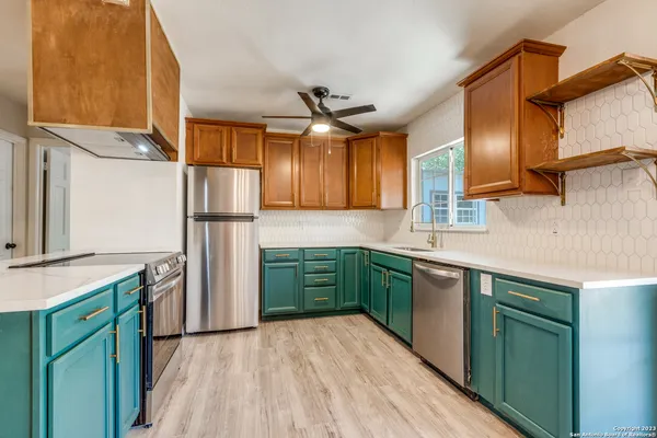a kitchen with a sink dishwasher a refrigerator and a stove